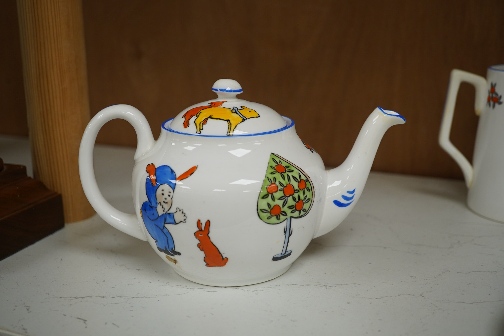 A Marjory Drew New Chelsea children's tea set and a Bunnykins mug. Condition - one cup badly restored